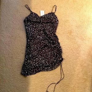 Cocktail / party dress that is black with white polka dots.